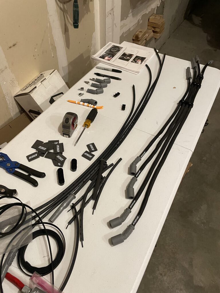 Coil relocation brackets and custom spark plug wires laid out before install
