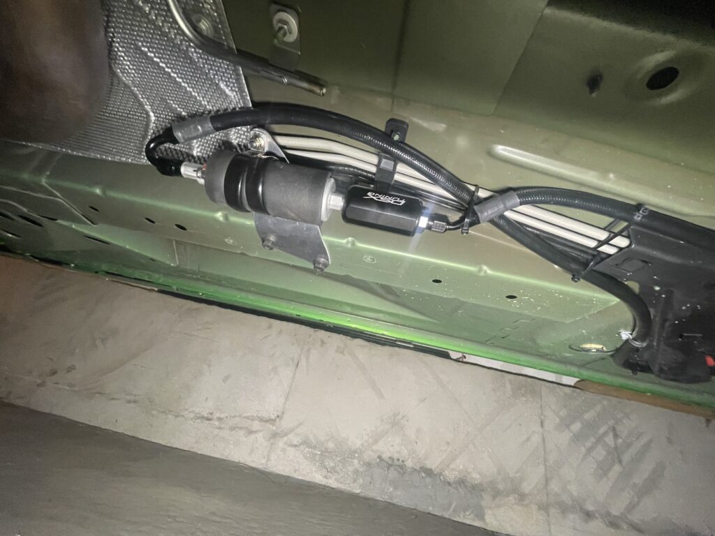 Auxiliary fuel pump and filter mounted underneath a 2012 Camaro SS